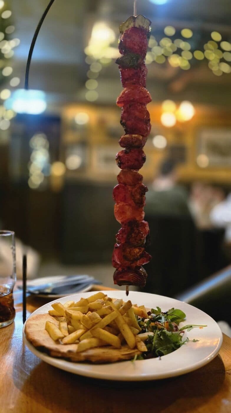 A showstopping hanging kebab at The Lakeside Inn, served sizzling over chips and flatbread